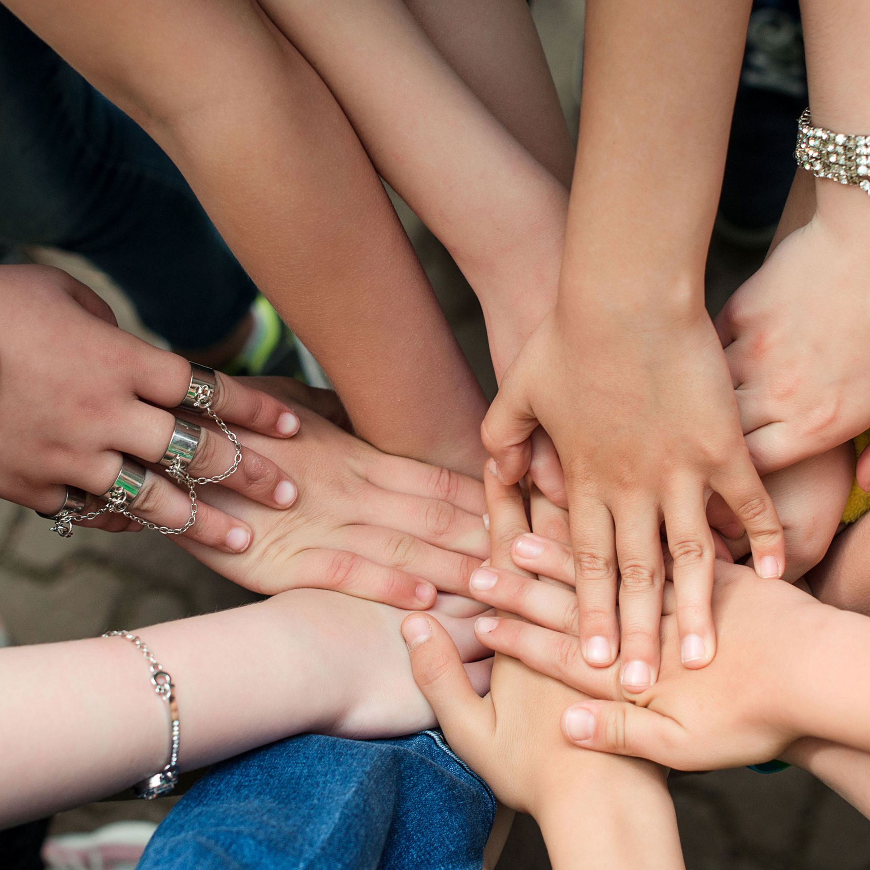 En masse unge der holder hænderne sammen