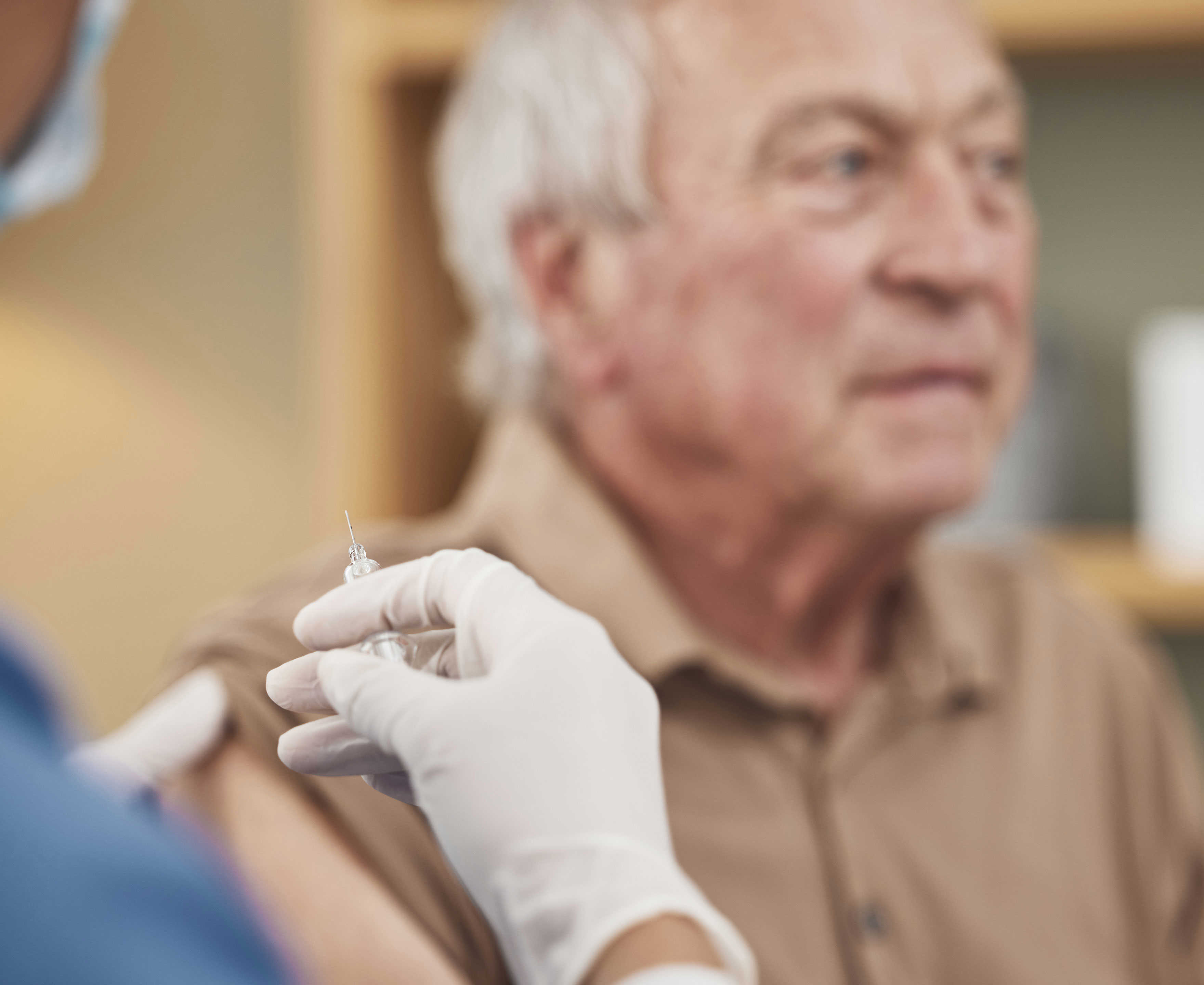 Ældre herre der venter på at blive vaccineret